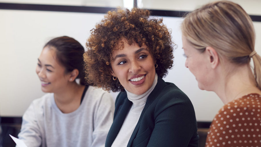 three women in a business meeting