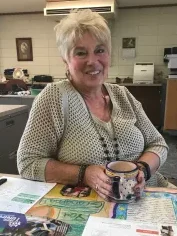 Judy sitting at her desk