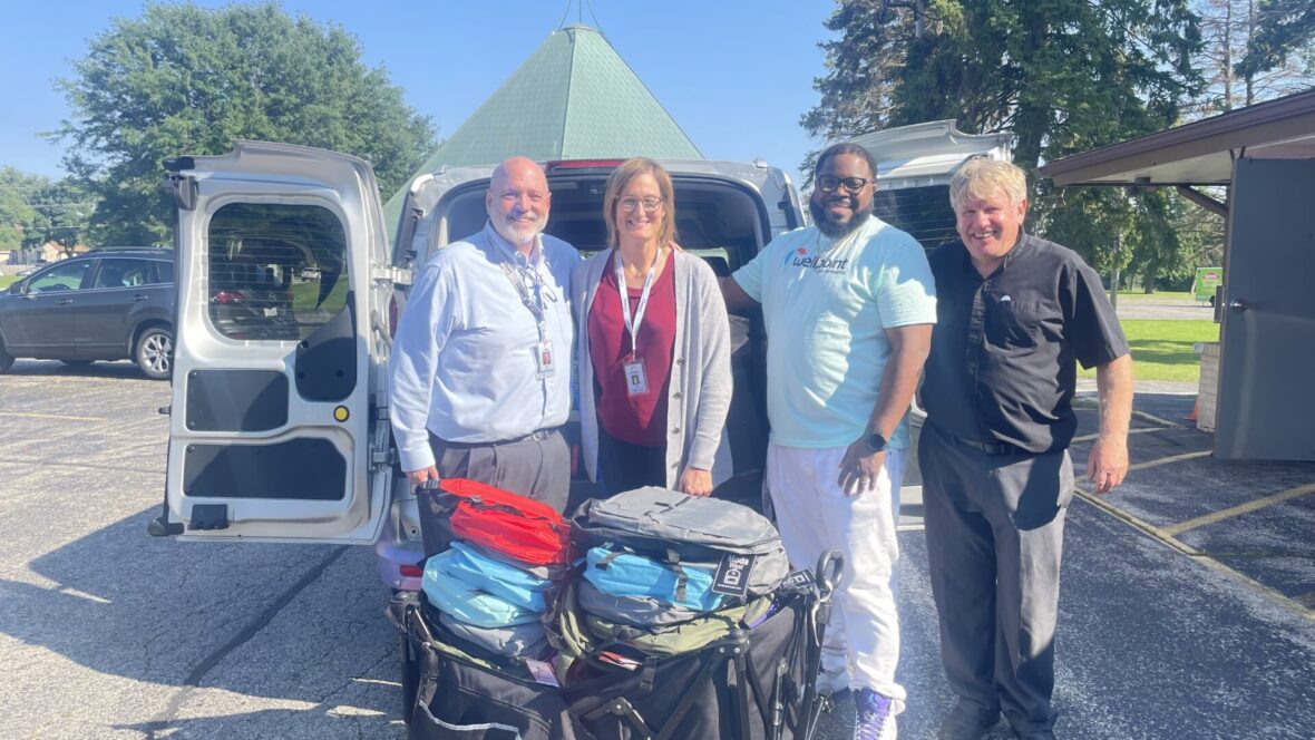 people donating backpacks