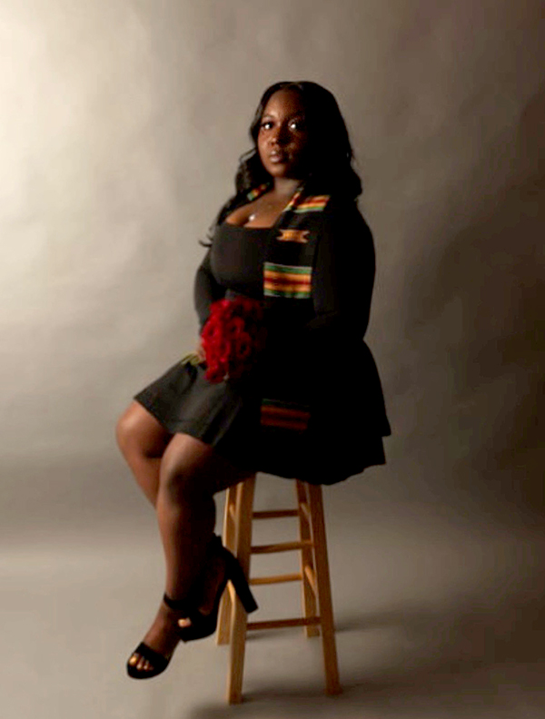 Author's Portrait of Briana T. Perkins, seated on a stool