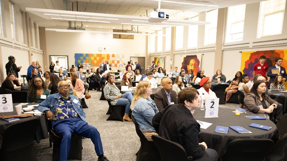 people sitting in large room